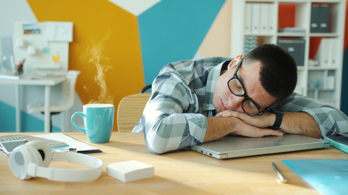 Exhausted office worker resting at a desk